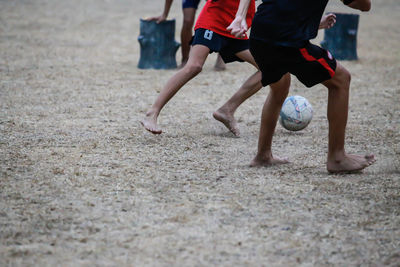 Low section of people playing soccer