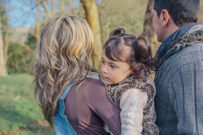 Rear view of mother and daughter outdoors