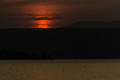 Scenic view of silhouette landscape against sky at sunset