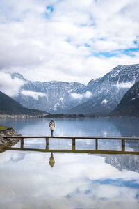 Scenic view of lake and snowcapped mountains against sky