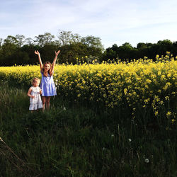 Portrait of sisters standing amidst plants