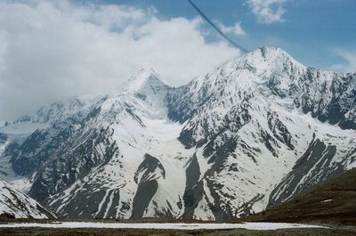 Scenic view of snow covered mountains against sky