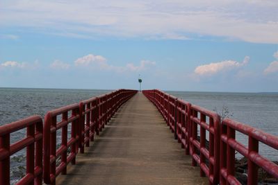 Pier over sea against sky