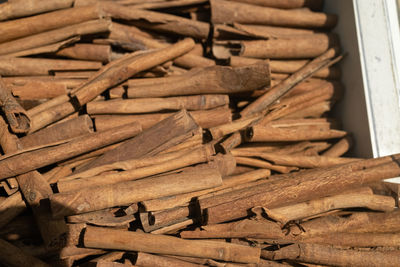 Cinnamon sticks in a bazaar collection of cinnamomum camphora bark over wooden background images