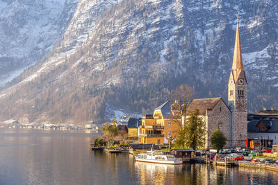 View of beautiful hallstatt lake and famous church during morning sunrise in early spring