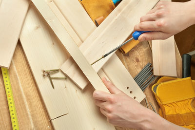 Close-up of carpenter cutting wood