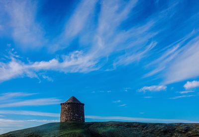 Scenic view of landscape against blue sky