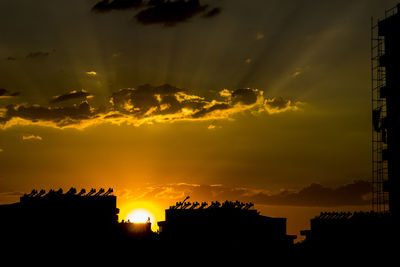 Silhouette of built structure against dramatic sky