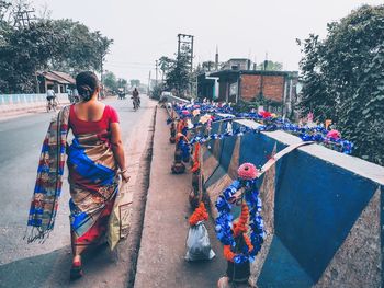 Rear view of people on street in city