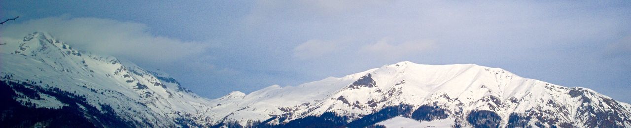 Scenic view of snow covered mountains against sky