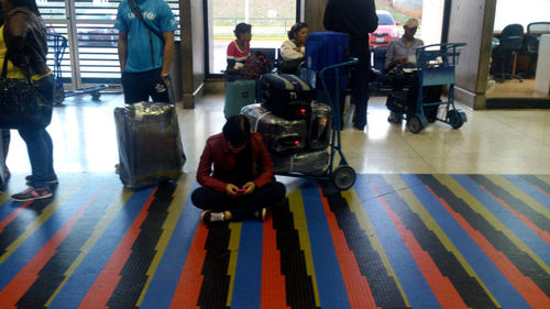 Group of people sitting on tiled floor