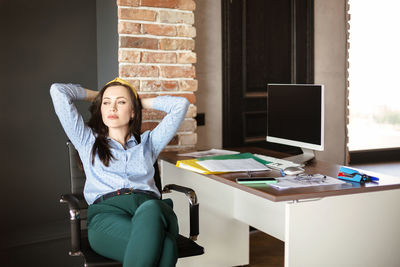 Young woman sitting on table