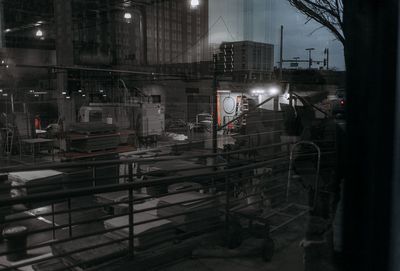 Reflection of buildings in city seen through train window