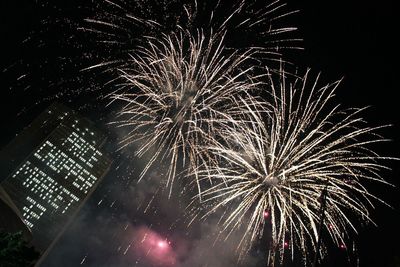 Low angle view of firework display at night