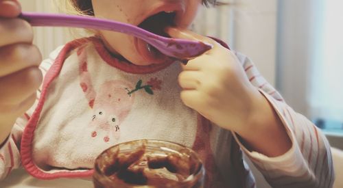 Midsection of woman eating ice cream