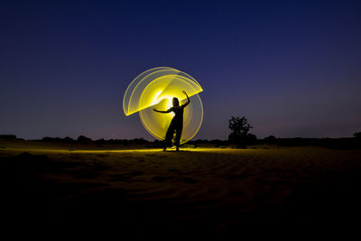 Person standing on field against sky