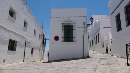 Street amidst buildings against sky