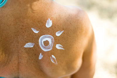 Close-up of shirtless man lying on land