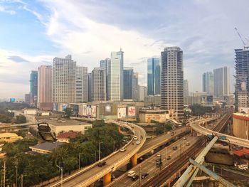 High angle view of city against cloudy sky