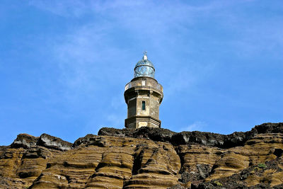 Low angle view of lighthouse ponta dos capelinhos against sky