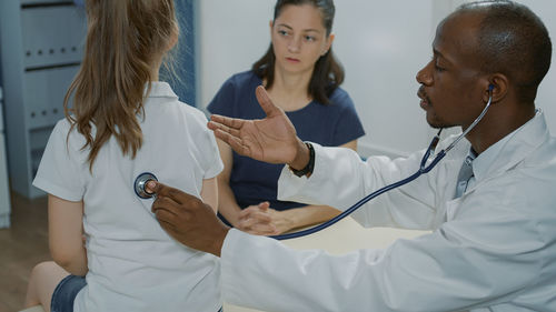 Doctor examining patient in hospital