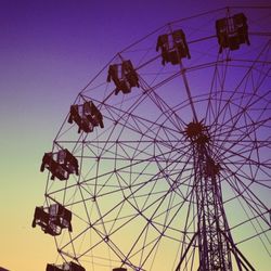 Low angle view of ferris wheel against blue sky