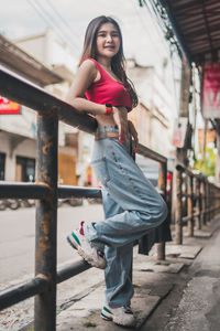 Portrait of smiling young woman standing outdoors