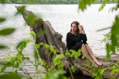 Portrait of young woman sitting in water