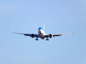 Low angle view of airplane flying in clear sky