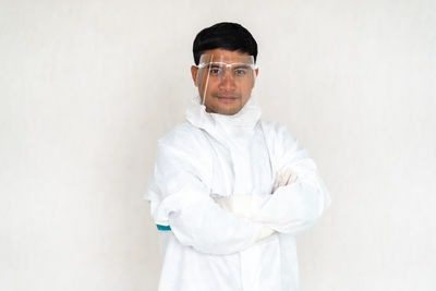 Portrait of man standing against white background