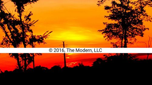 Silhouette of information sign at sunset