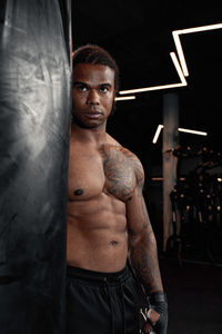 Portrait of young man exercising in gym