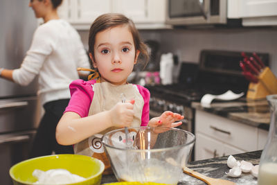 Cute girl preparing food on table at home