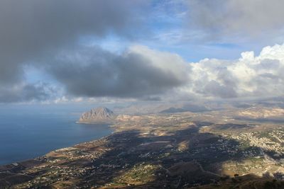 Aerial view of sea and land against sky