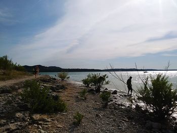 Man standing on beach against sky