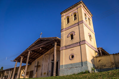 Low angle view of building against clear blue sky