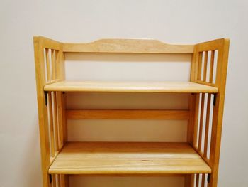 Close-up of empty chair on table against wall at home