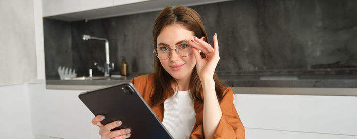 Young woman using digital tablet at home