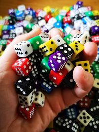 Close-up of hand holding multi colored pencils