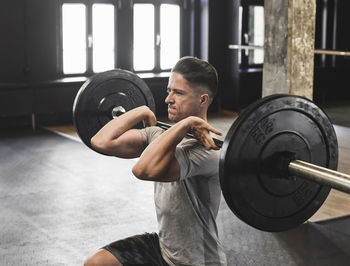 Man exercising with barbells