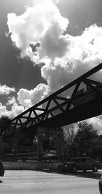 Low angle view of bridge against cloudy sky