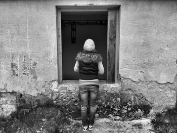 Full length of woman standing on wall