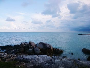 Rocks in sea against sky