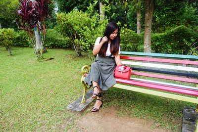 Full length of woman sitting in park