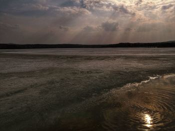 Scenic view of beach against sky during sunset