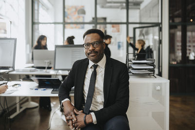 Portrait of mature businessman sitting at corporate office