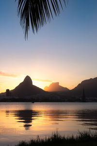 Scenic view of silhouette mountains against sky during sunset