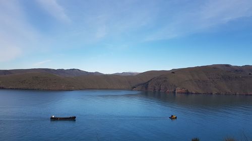 Scenic view of lake against blue sky