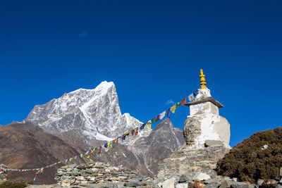 Low angle view of temple against clear blue sky