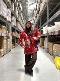 Portrait of woman standing in warehouse